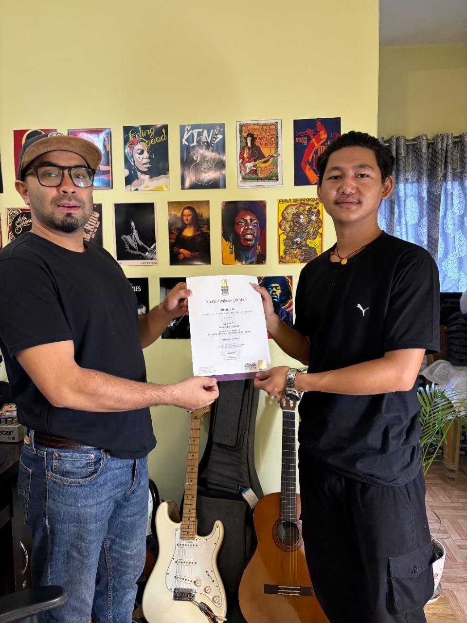 Bipul receiving Trinity College Grade 5 Certification
